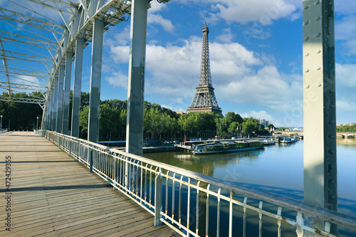 View of Eiffel Tower from the bridge with reflection on Seine river in Paris, France