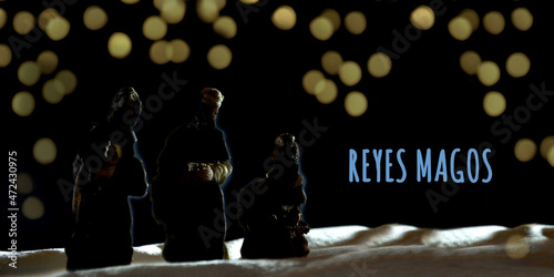 Obraz na plátně silhouette of mages on dark background with light spots with text reyes magos