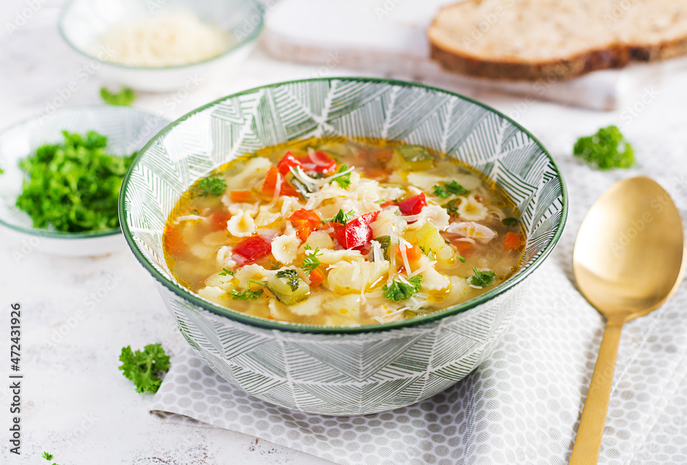 Minestrone, italian vegetable soup with pasta on light table.