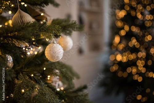 Decorative christmas white balls on a tree with bokeh in the background, shallow depth of field, new year decor, merry christmas