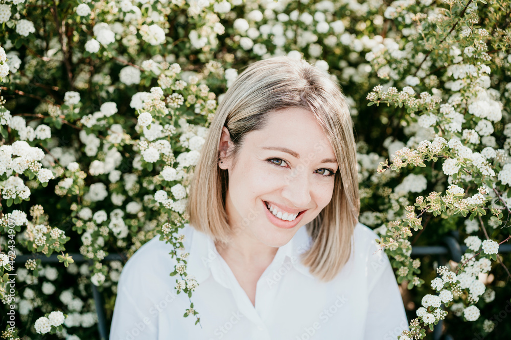 Smiling woman amidst white flowers Smiling woman amidst white flowers