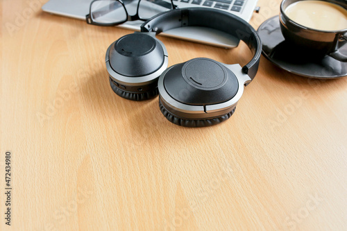 Black headphones on wooden background. Work-Life Balance concept photo