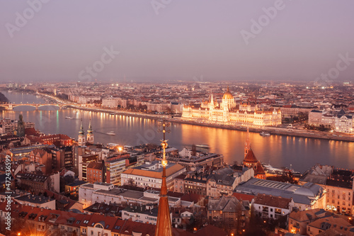 View at dusk of the Danube and the Hungarian Parliament building in Budapest, Hungary. Sunset autumn light, dusk. View from the bell tower of the Matthias Church in Buda