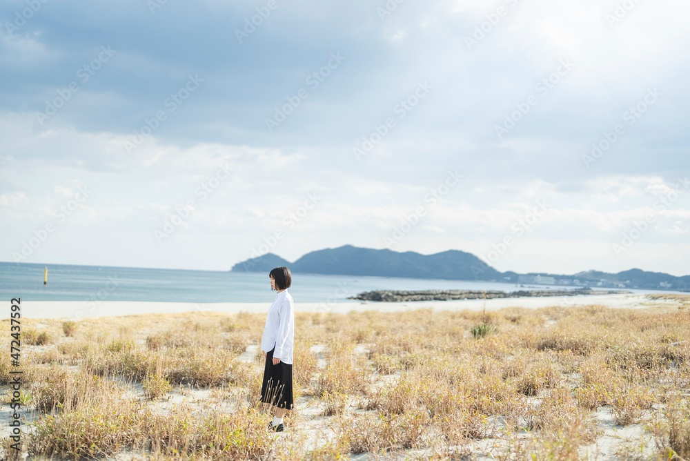 冬の海や湖を旅する女性