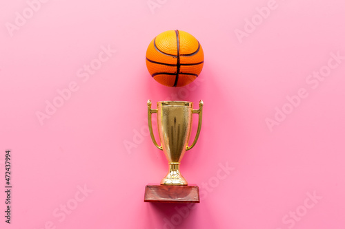 Sport champion award - golden trophy cup with game ball  top view