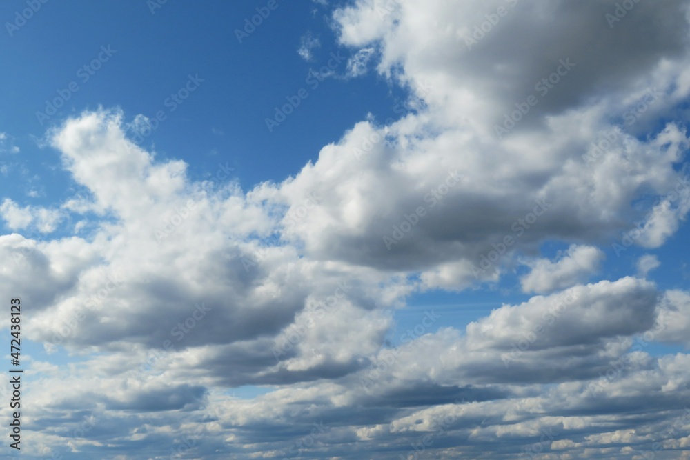 Blue sky background with white cumulus clouds