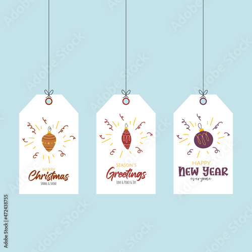 Holiday printable greetings labels with doodle christmas balls for giftsand wishes. Festive handwritten toys orange, red and purple colors on blue background. photo