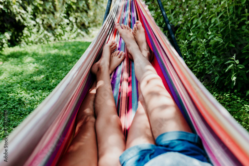 Girls lying in hammock on sunny day photo