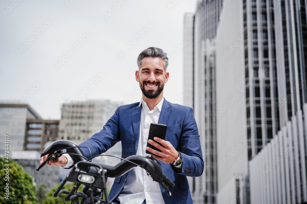 Businessman with mobile phone and rented bicycle in city Businessman with mobile phone and rented bicycle in city