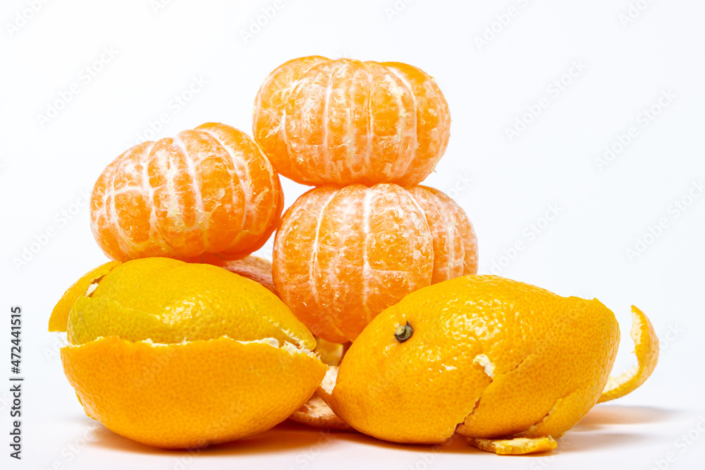 Peeled tangerines on a tangerine peel on a white background. Isolated tangerine Peeled tangerines on a tangerine peel on a white background. Isolated tangerine