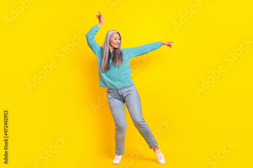 Full length body size view of attractive cheerful carefree woman dancing isolated on bright yellow color background