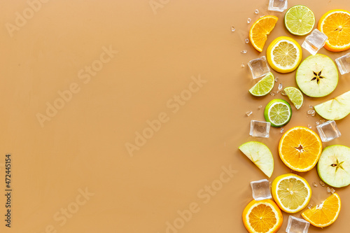 Slices citrus fruits and berries with with ice for making cocktail or juice