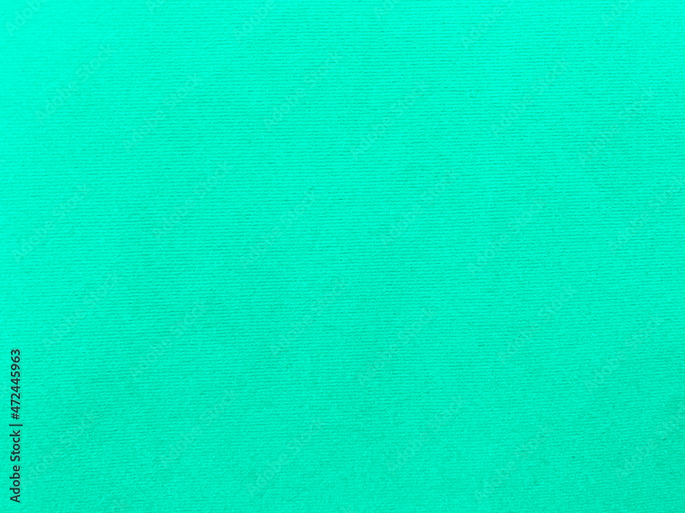 Mint green velvet fabric texture used as background. Empty green fabric background of soft and smooth textile material. There is space for text..