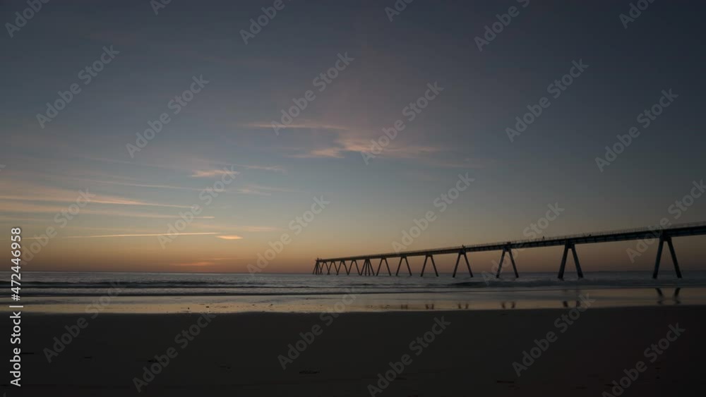 MAGNIFICENT SUNSET ON THE BEACH OF LA SALIE SUD IN LANDES ACCOMPANIED BY ITS WHARF MAGNIFICENT SUNSET ON THE BEACH OF LA SALIE SUD IN LANDES ACCOMPANIED BY ITS WHARF