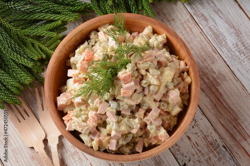Russian salad "Olivier" with vegetables and meat, and mayonnaise. Winter salad. Rustic style. Traditional Christmas and New year salad