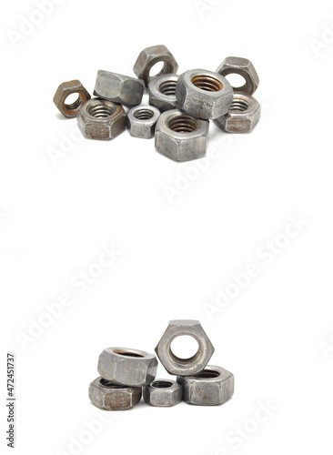Rusty nuts on white background close-up. steel, thread, fasteners, industry, engineering, mechanical engineering, carving 