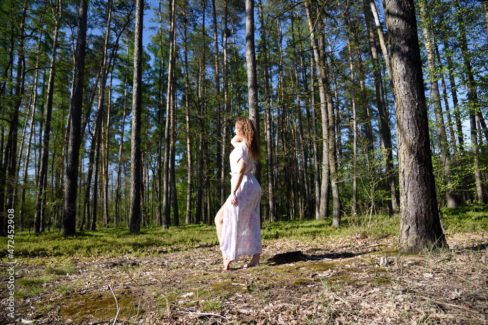 Pretty, young woman posing in the forest. Green surroundings during spring in Poland. Pretty, young woman posing in the forest. Green surroundings during spring in Poland.