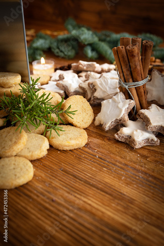Different homemade christmas cookies with spices on vintage wood. Vertical background with short depth of field for the sweet christmas baking.