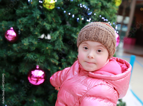 Portrait of young girl on background of the christmas tree