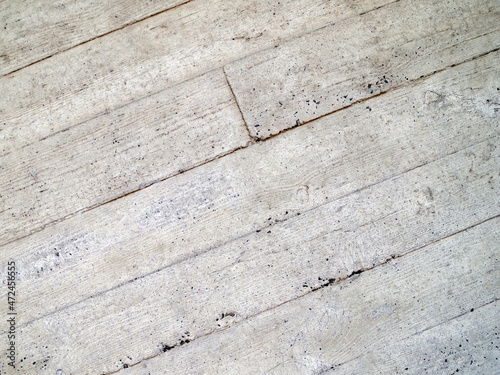 Concrete surface with diagonal joints. Background with wood texture.