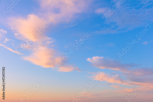 Light cirrus clouds in the blue sky during dawn sunset  real pastel colors
