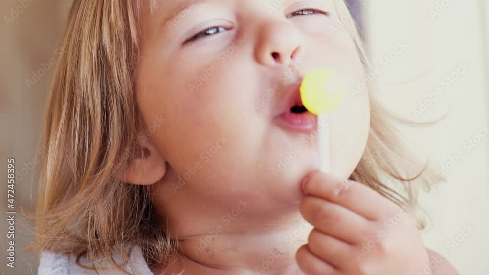 Pretty little girl with a bright lollipop. Studio shot Pretty little girl with a bright lollipop. Studio shot