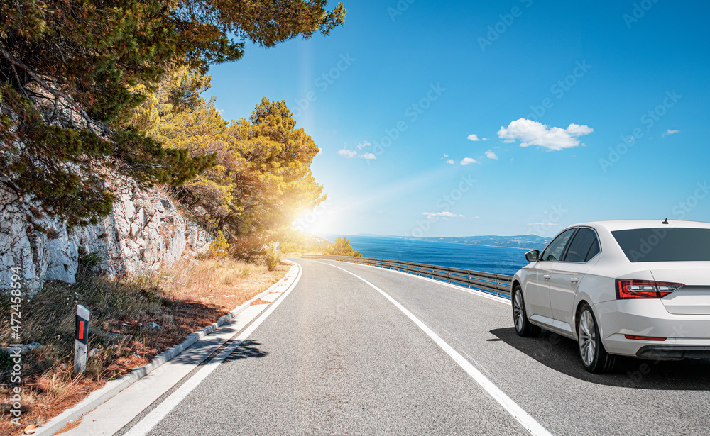 Car on the highway along the sea coast. Vacation or car rental concept.