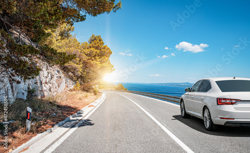 Obraz na płótnie Car on the highway along the sea coast. Vacation or car rental concept. w salonie
