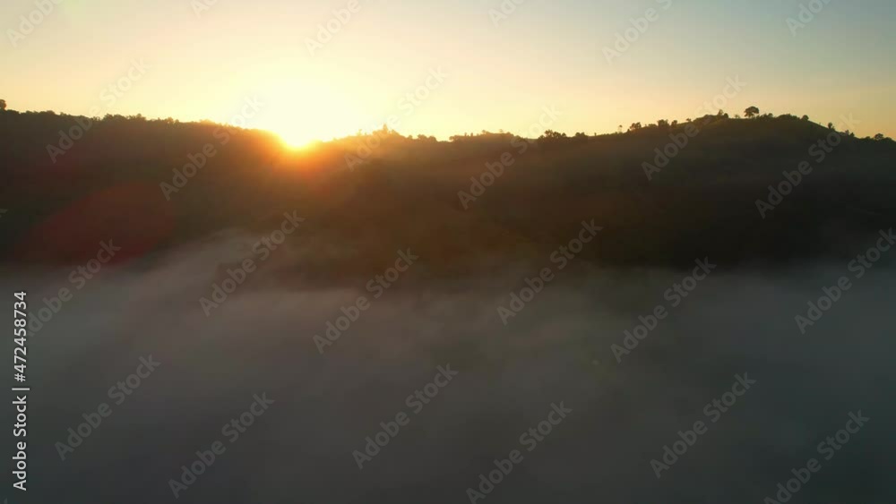 4K Aerial view flying in fog. the sun is hidden behind the clouds at sunset fog.
4K Aerial view flying in fog. the sun is hidden behind the clouds at sunset fog.