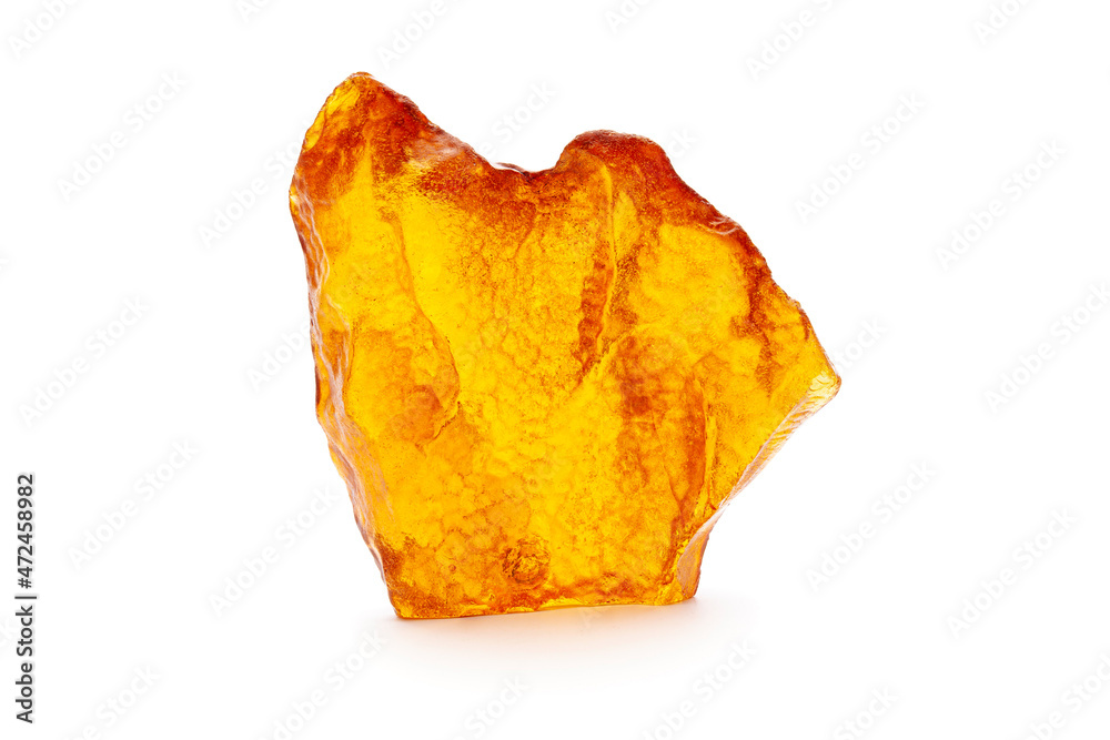 Natural amber. A piece of yellow opaque natural amber on white background.