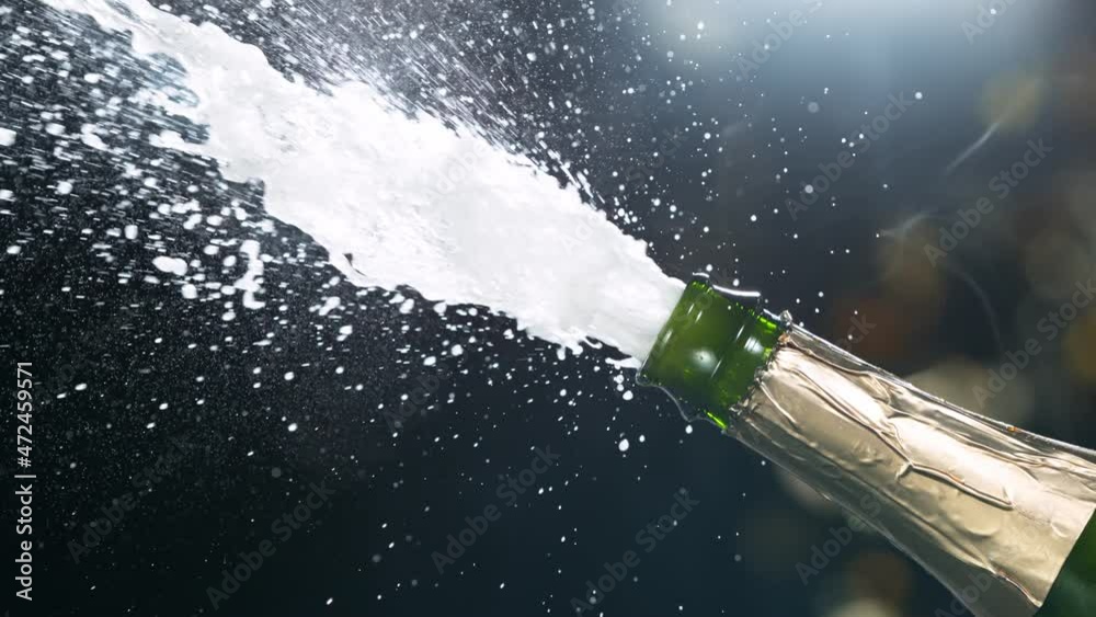Super slow motion of Champagne explosion with flying cork closure, opening champagne bottle closeup. Filmed on high speed cinematic camera at 1000 frames per second.