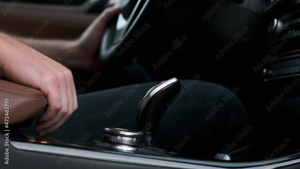 Man shifts gears with joystick with one hand