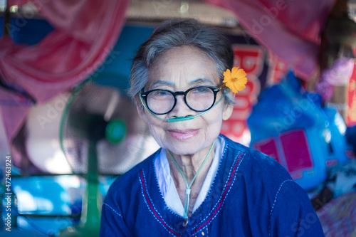 Elderly patients wear oxygen tubes through their noses to help them breathe. Concept of disease in the elderly.