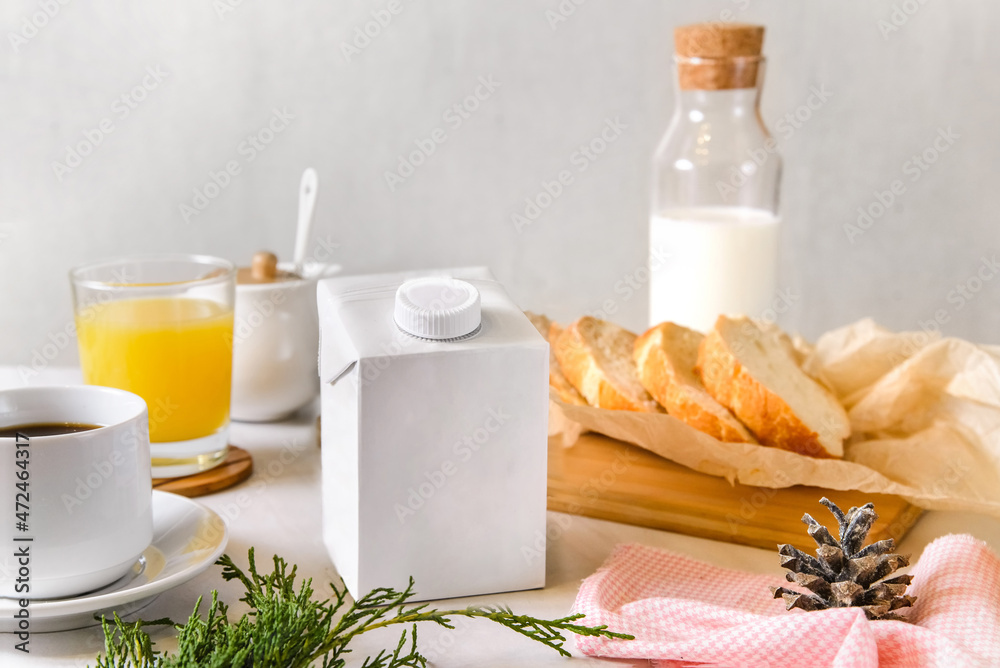 blank half liter milk box packaging with lid on a table with breakfast. package template, mockup of a retail container for liquid products. blank half liter milk box packaging with lid on a table with breakfast. package template, mockup of a retail container for liquid products.