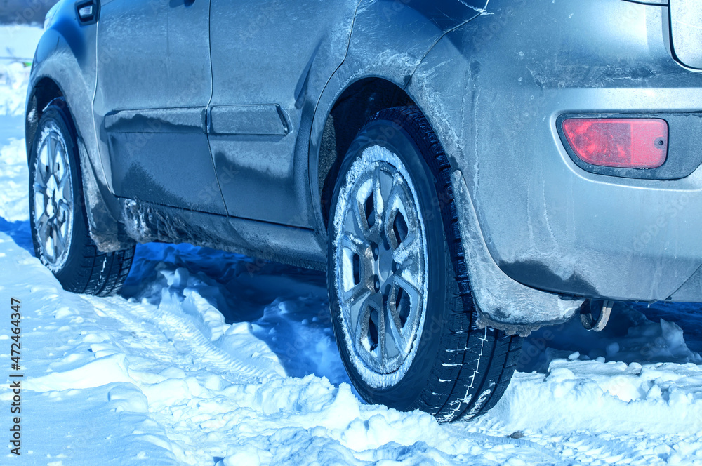 Winter car tyres on a snowy road