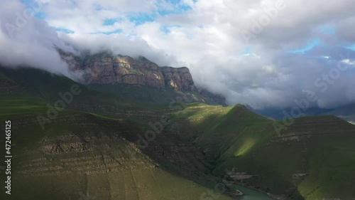 Slow motion of wild clear mountain river , stream flowing through rocks. Close up of river stones with flowing water, clean water flowing in a mountain river
