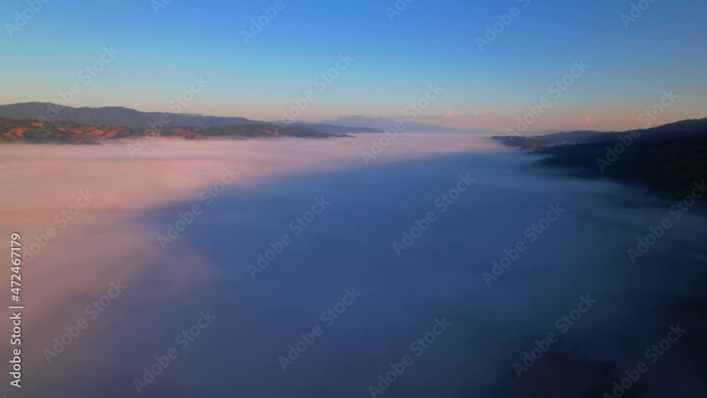 4K Drone Flying through the clouds at dusk or dawn. Aerial top cloudscape view from drone. Tropical forest with smoke and fog.
4K Drone Flying through the clouds at dusk or dawn. Aerial top cloudscape view from drone. Tropical forest with smoke and fog.