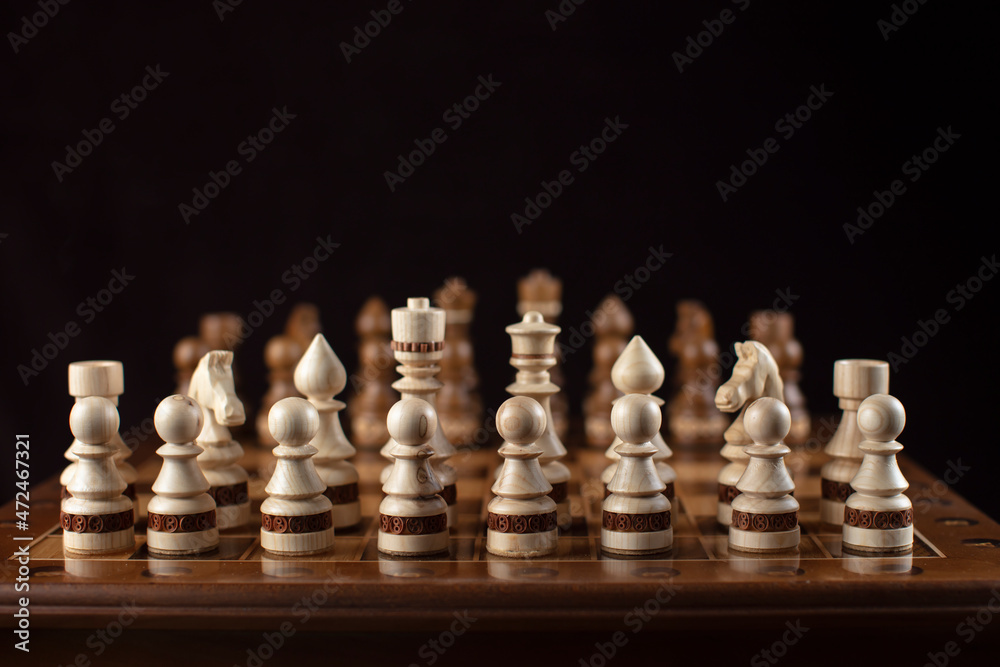 Chess on a dark background. A puzzle game with tricky combinations that requires planning and thinking.