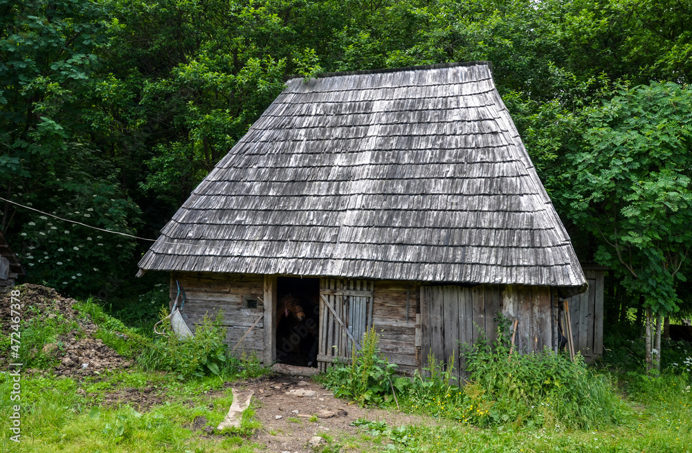 Rural landscape with traditional old wooden houses in Carpathian village. Ukrainian countryside Rural landscape with traditional old wooden houses in Carpathian village. Ukrainian countryside