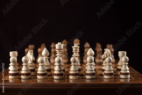Chess on a dark background. A puzzle game with tricky combinations that requires planning and thinking.