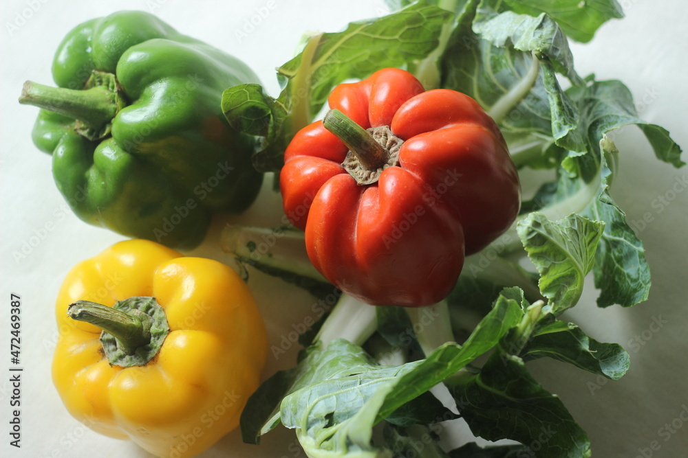 Red yellow and green bell peppers. Bell pepper or Capsicum annuum, also called sweet pepper or capsicum Red yellow and green bell peppers. Bell pepper or Capsicum annuum, also called sweet pepper or capsicum