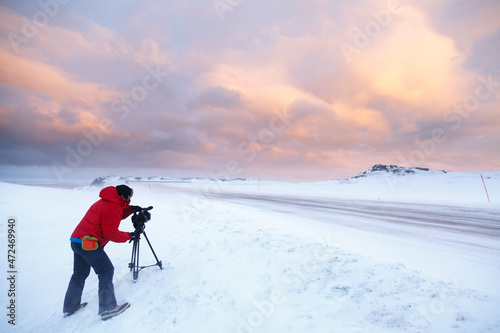 Man recording video on the maple of a snowy road