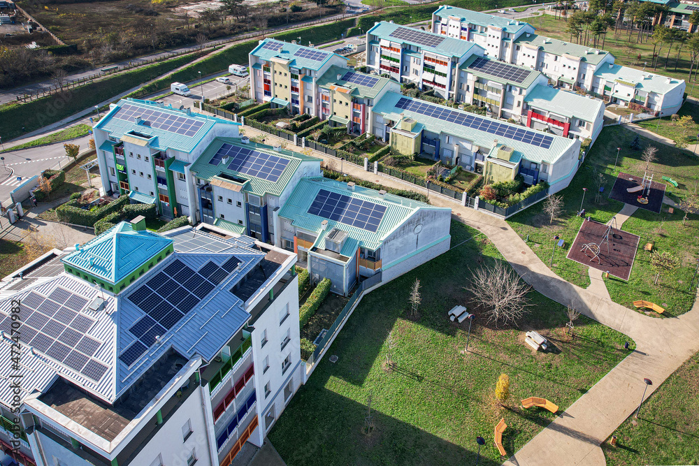 Modern houses with solar panels on the roof for alternative energy. Grugliasco, Italy - November 2021