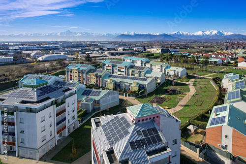 Modern houses with solar panels on the roof for alternative energy. Grugliasco, Italy - November 2021