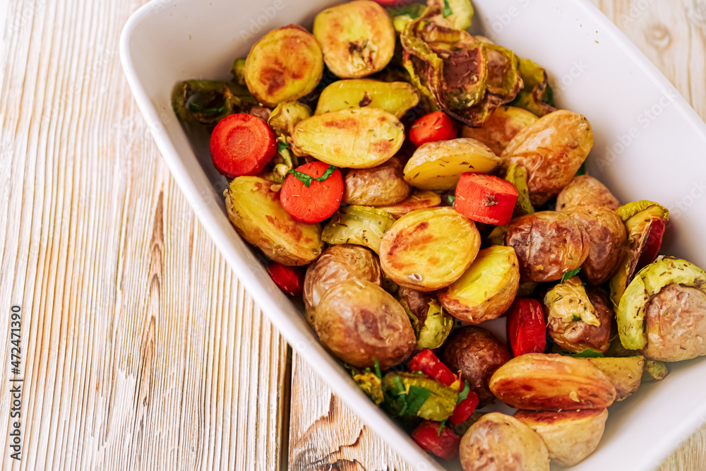 Oven baked vegetables in a baking dish. Vegetable dish close-up. Assorted vegetables roasted with spices, vegan recipe, copy space Oven baked vegetables in a baking dish. Vegetable dish close-up. Assorted vegetables roasted with spices, vegan recipe, copy space