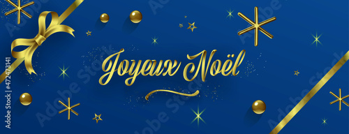 carte de voeux bleue, Joyeux Noël doré en relief avec des étoile scintillantes,un gros noeud et des boules dorées