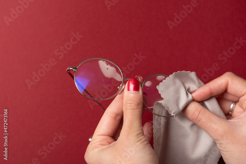 Woman hands cleaning glasses with mist