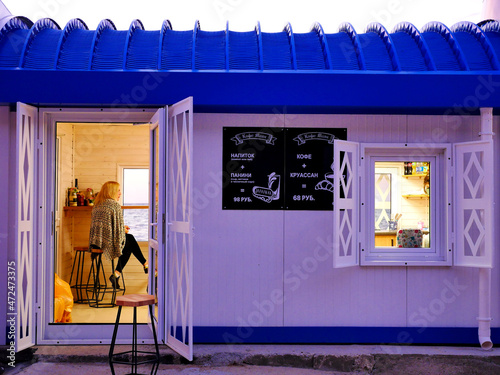 Cafe on the beach. Inscription in Russian: Drink (compote or tea) + panini (cheese, ham and garlic sauce) = 98 rubles. Coffee + croissant = 68 rubles 