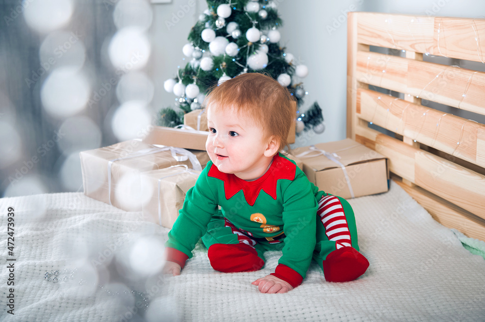 Child dressed as Santa Claus and Elves with Christmas gifts. Baby in suits for New Year.. Child dressed as Santa Claus and Elves with Christmas gifts. Baby in suits for New Year..