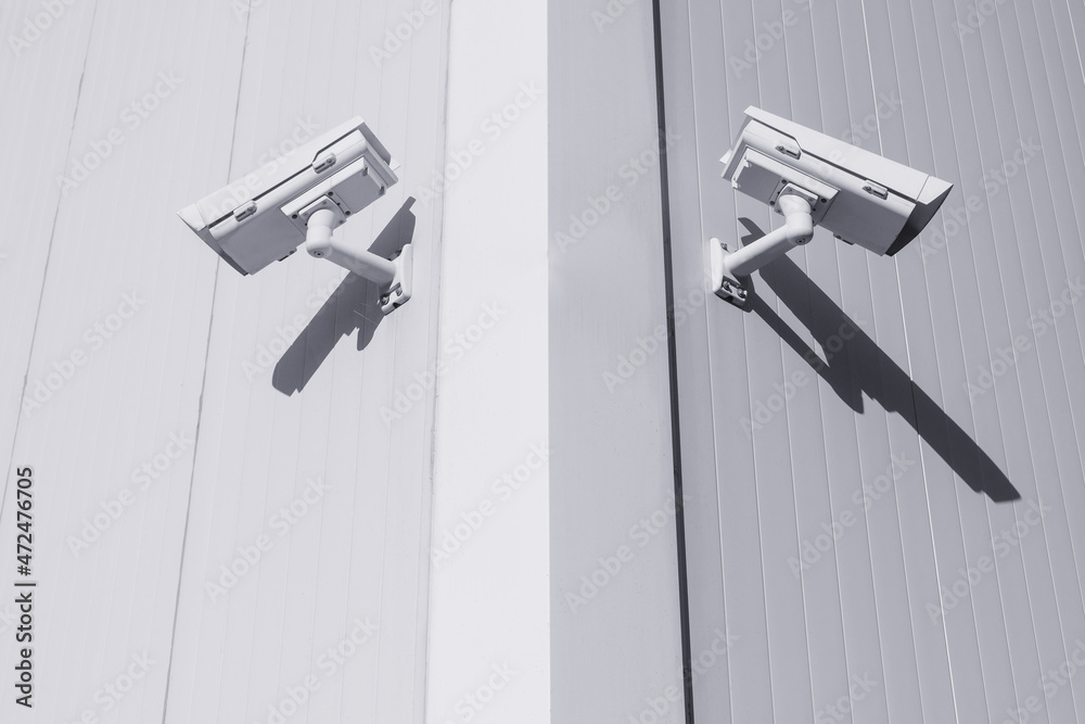 Two CCTV cameras in different directions at the corner of the building to control objects Two CCTV cameras in different directions at the corner of the building to control objects